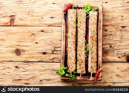 Raw kebabs in skewers. Caucasian popular dish, kebab from young lamb meat and spices.Fast food