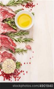 Raw lamb chops with oil and spices, preparation on white wooden background, frame, place for text