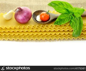 raw lasagna sheets with spices on white background