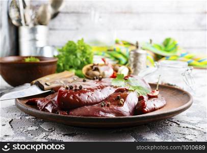 raw liver on plate on a table