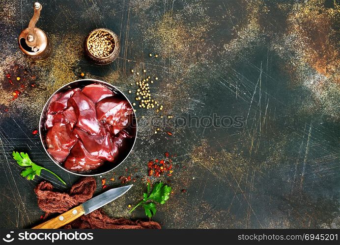 raw liver with salt and spice on a table