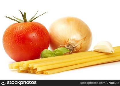 raw macaroni with basil, tomato, onion and garlic clove . raw macaroni with basil, wet tomato, onion and garlic clove on white background