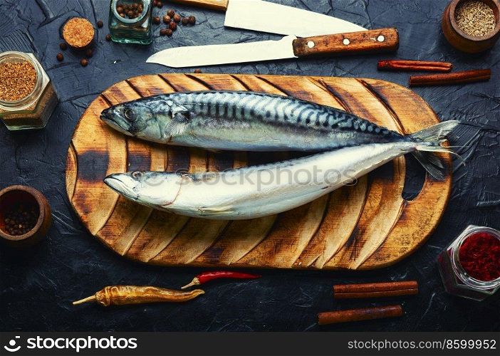 Raw mackerel fish and spices on the kitchen table. Seafood. Fresh, raw scomber fish