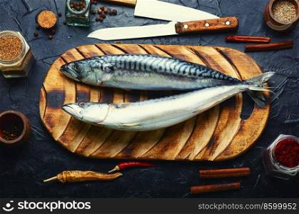 Raw mackerel fish and spices on the kitchen table. Seafood. Fresh, raw scomber fish