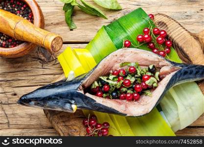 Raw mackerel stuffed with berries. Fish with currant filling.. Fresh raw with berry filling