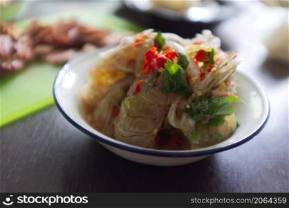 Raw mantis shrimp dressing spicy and sour fish sauce . THAI food