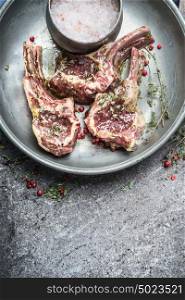 Raw marinated lamb chops for barbecue grilling or frying , top view, close up, copy space