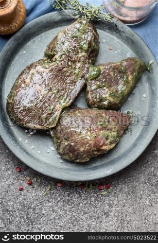 Raw marinated steak for barbecue grilling or frying , top view, close up, copy space