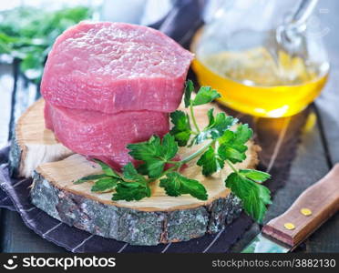 raw meat and parsley on the table