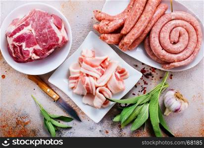 raw meat and raw sausages on the wooden board