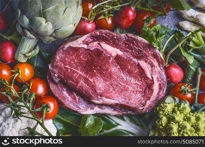 Raw meat and various vegetables: Artichokes , tomatoes,broccoli, asparagus, cauliflower, top view, close up, copy space