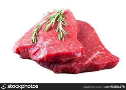 raw meat beef steak with rosemary isolated over white. raw beef steak isolated on white background.