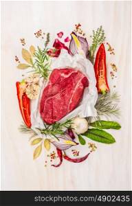 Raw meat, composing with herbs,spices and seasoning on white wooden background, ingredients for cooking, top view