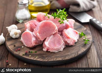 Raw meat, fillet, tenderloin on wooden background