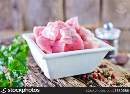 raw meat in bowl and on a table