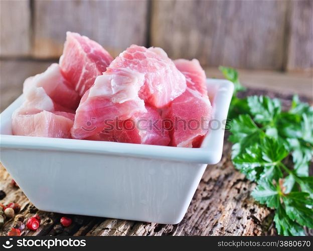 raw meat in bowl and on a table