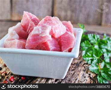 raw meat in bowl and on a table