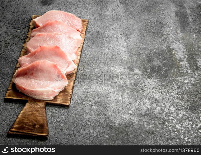 Raw meat of pork . On rustic background.. Raw meat of pork .