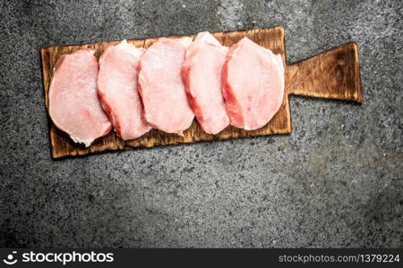 Raw meat of pork . On rustic background.. Raw meat of pork .