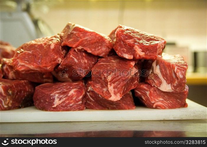 Raw meat on a butcher&acute;s cutting board.