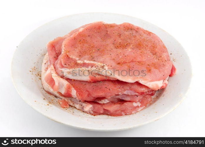 raw meat on the white dish