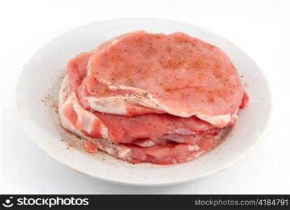 raw meat on the white dish