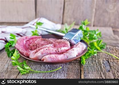 raw meat on the wooden board and on a table