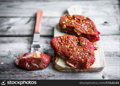 Raw meat on wooden background