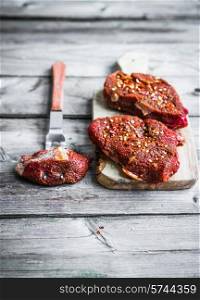 Raw meat on wooden background