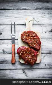 Raw meat on wooden background