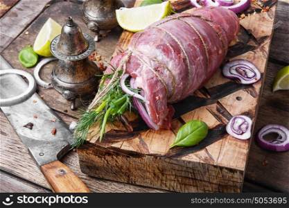 Raw meat on wooden cutting board. Raw beef meat on cutting board with spices