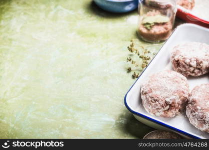 Raw meat patties on kitchen table