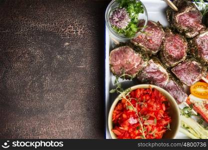 Raw Meat skewers preparation with fresh gut vegetables on rustic background, top view, border