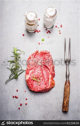 Raw meat Steak preparation on gray stone background, top view
