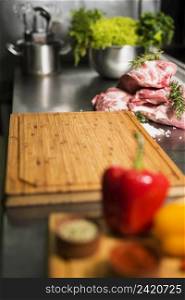 raw meat steaks with wooden board table