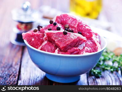 raw meat with aroma sxpice on a kitchen table