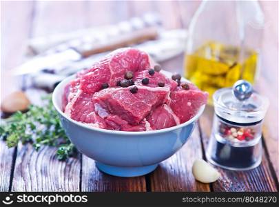 raw meat with aroma sxpice on a kitchen table