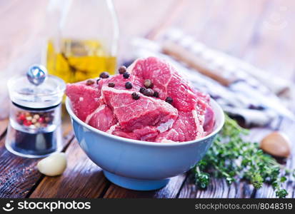 raw meat with aroma sxpice on a kitchen table