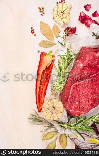 Raw meat with herbs and spices for cooking on white wooden background, top view, frame