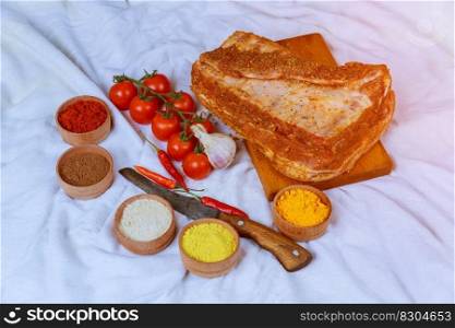 Raw meat with herbs, spices on white background. Raw pork steak. Ingredients for cooking meat Raw pork for pickling.. Raw meat with herbs, spices on white background. Raw pork steak. Ingredients for cooking meat