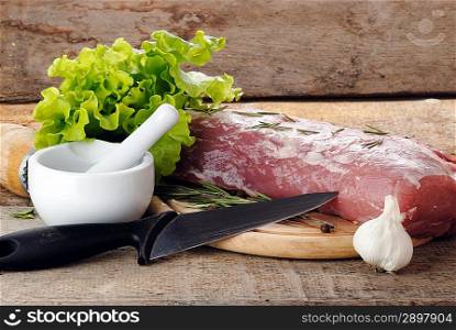 raw meat with lettuce and porcelain mortar