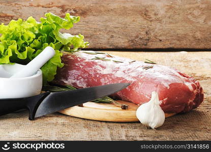 raw meat with lettuce and porcelain mortar