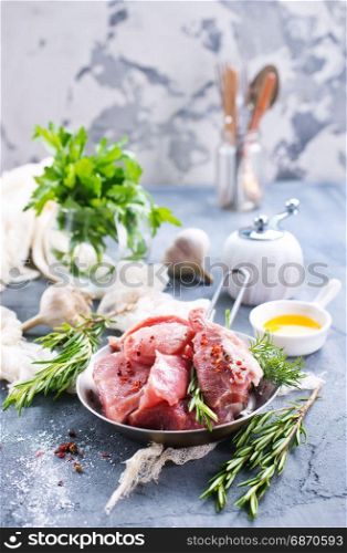 raw meat with oil and spice on a table
