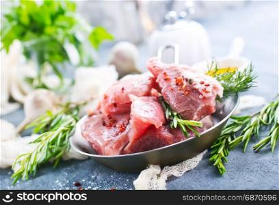 raw meat with oil and spice on a table