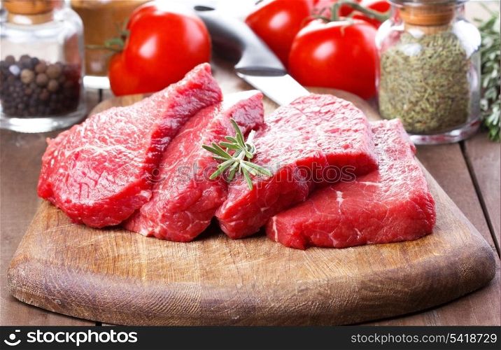 raw meat with rosemary and vegetables
