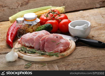 raw meat with rosemary, garlic and porcelain mortar