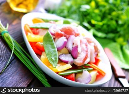 raw meat with vegetables in the bowl