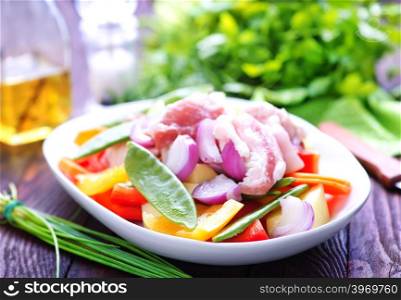 raw meat with vegetables in the bowl