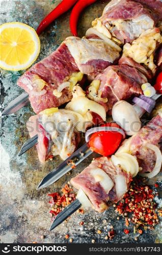 raw meat with vegetables threaded onto a skewer for roasting on the coals. raw meat on skewer