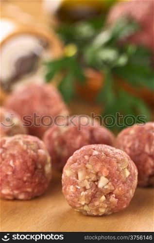 Raw meatballs with garlic (Selective Focus, Focus on the meatball in the front). Raw Meatballs